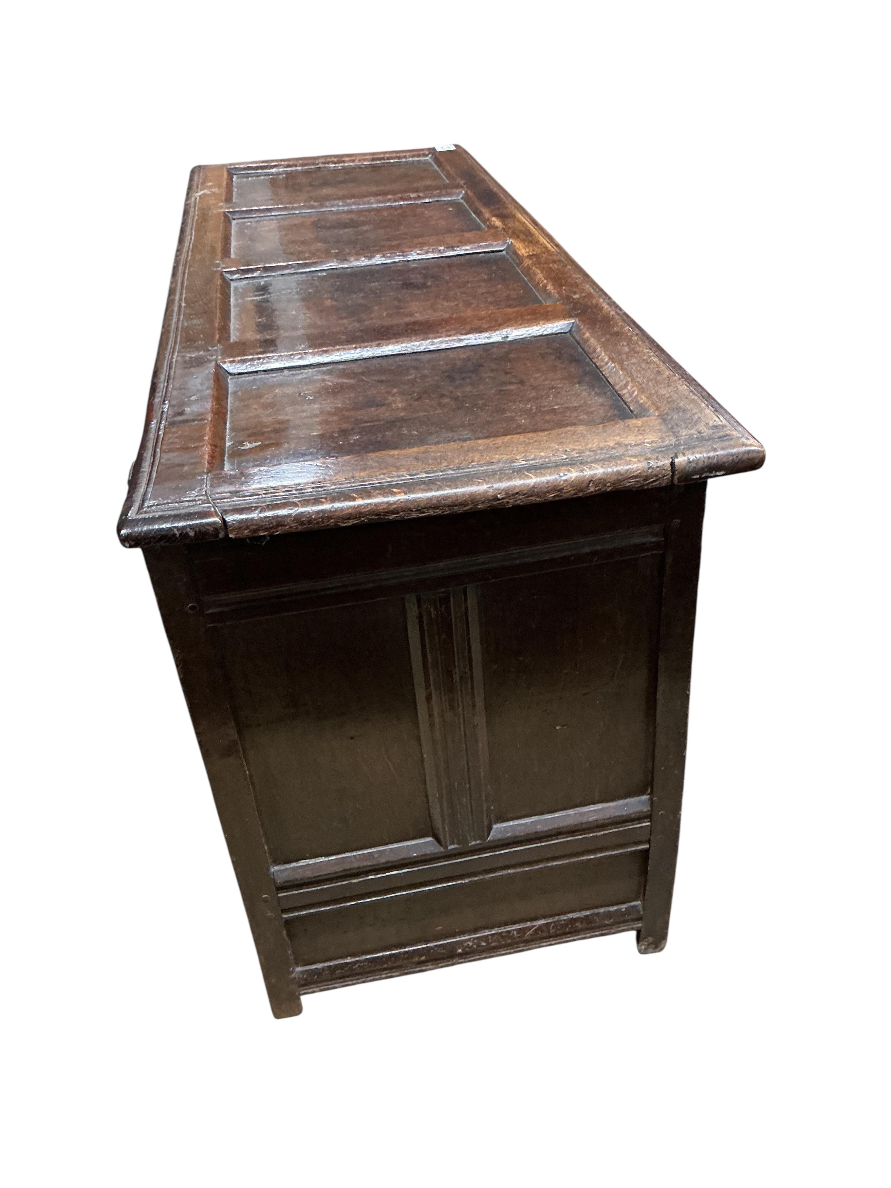 A late 17th century carved oak triple panelled coffer, the top rail monogrammed D.M, width 128cm, depth 48cm, height 68cm